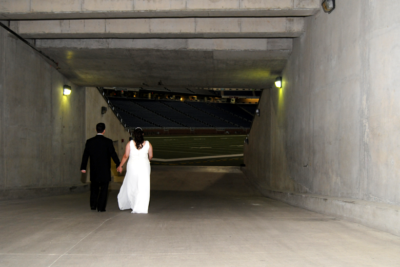 Bride and Groom walk down the tunnel to the football field