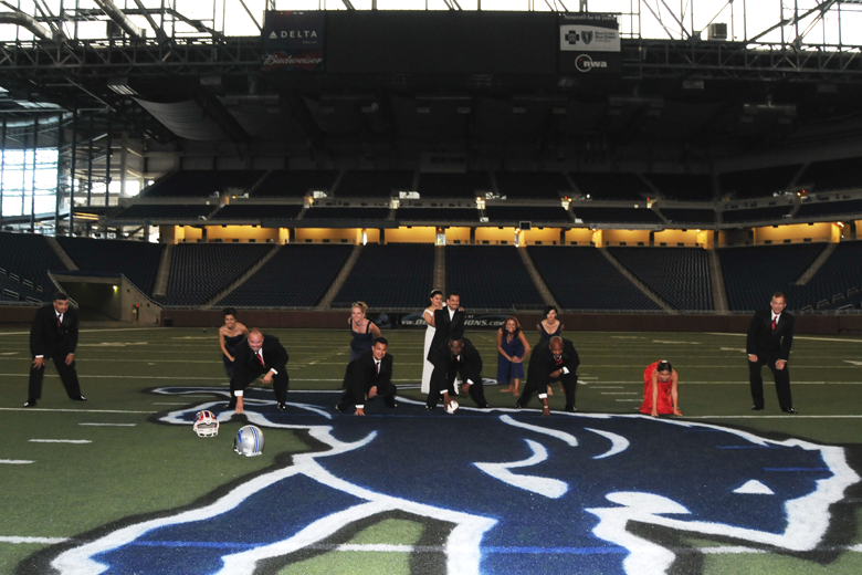 Wedding bridal party runs plays on the field at Ford Field in Detroit